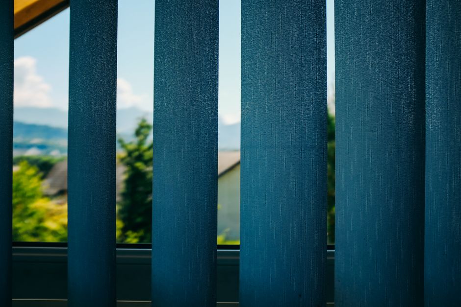 Sunlight streaming through modern roller shades