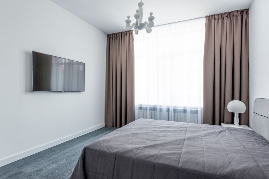 Soft custom drapes framing a bedroom window